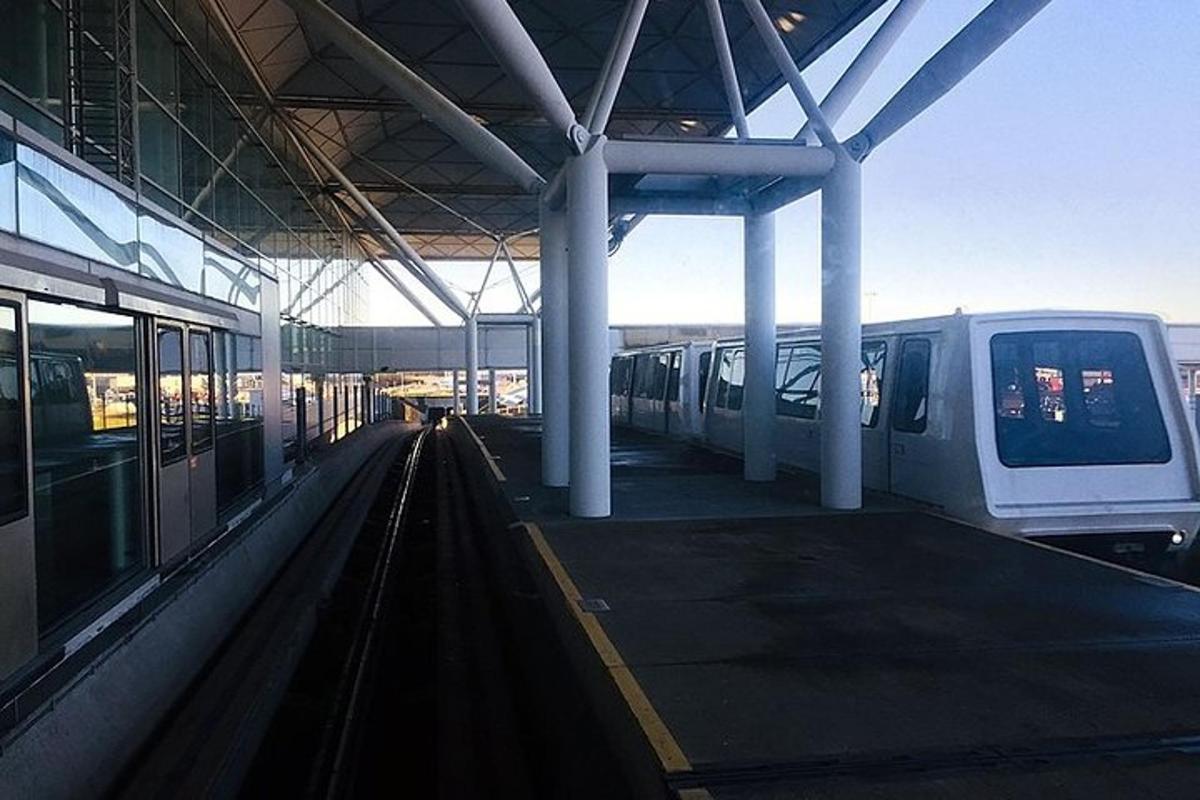a train station with two trains on the tracks