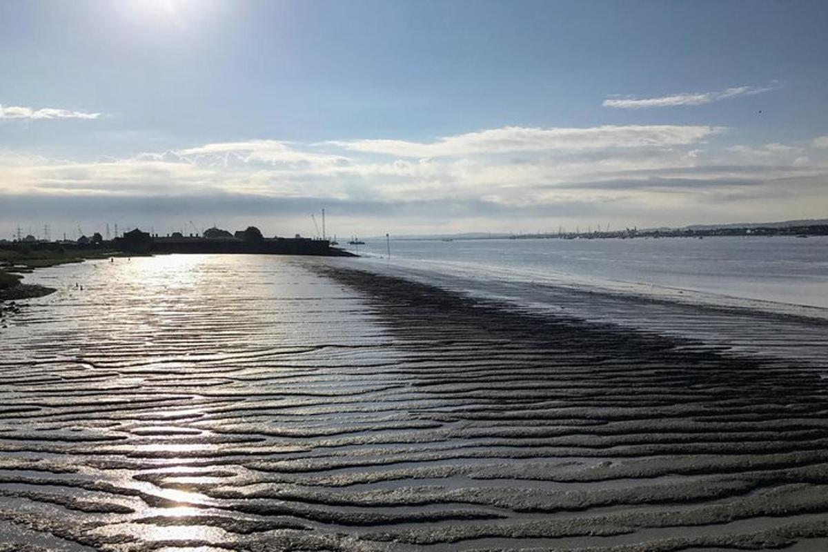 a beach with ripples in the sand and the water