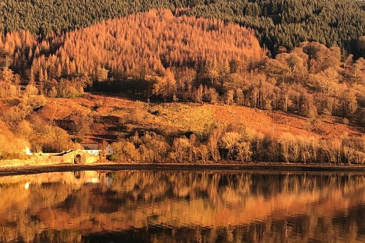 a reflection of a mountain in a body of water