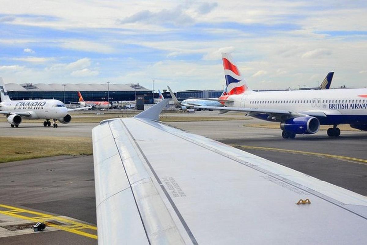 a view of the wing of an airplane at an airport