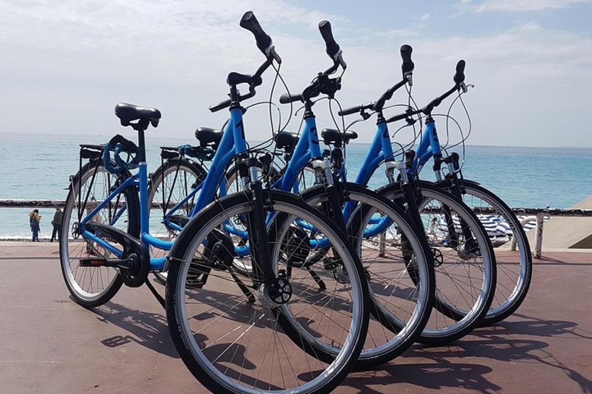 a row of bikes parked next to the beach