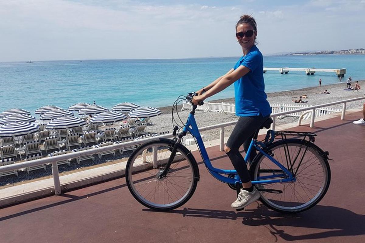 a woman riding a bike on the beach
