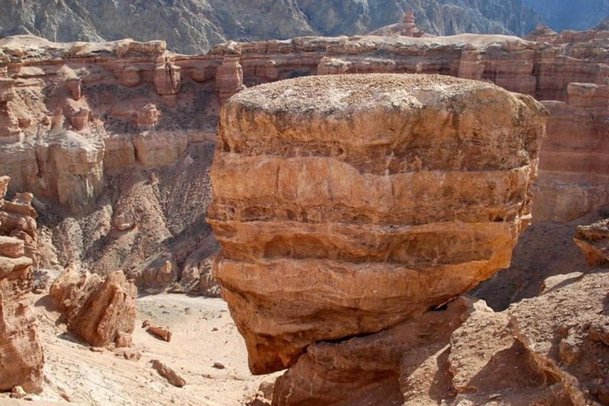 a large rock in a canyon in the desert