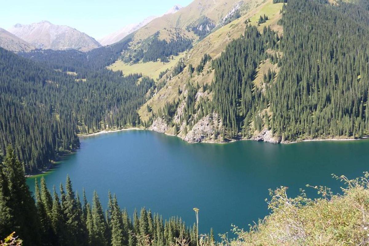 a large blue lake in the middle of a mountain