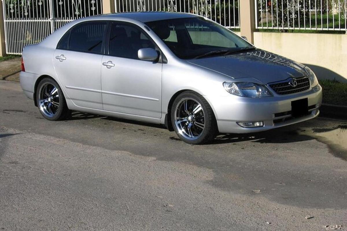 a silver car parked on the side of a street