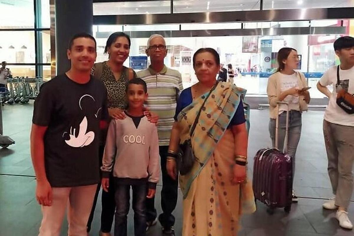 a family posing for a picture at an airport