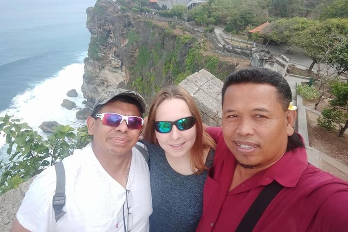 海で写真を撮る男性2人と女性1人