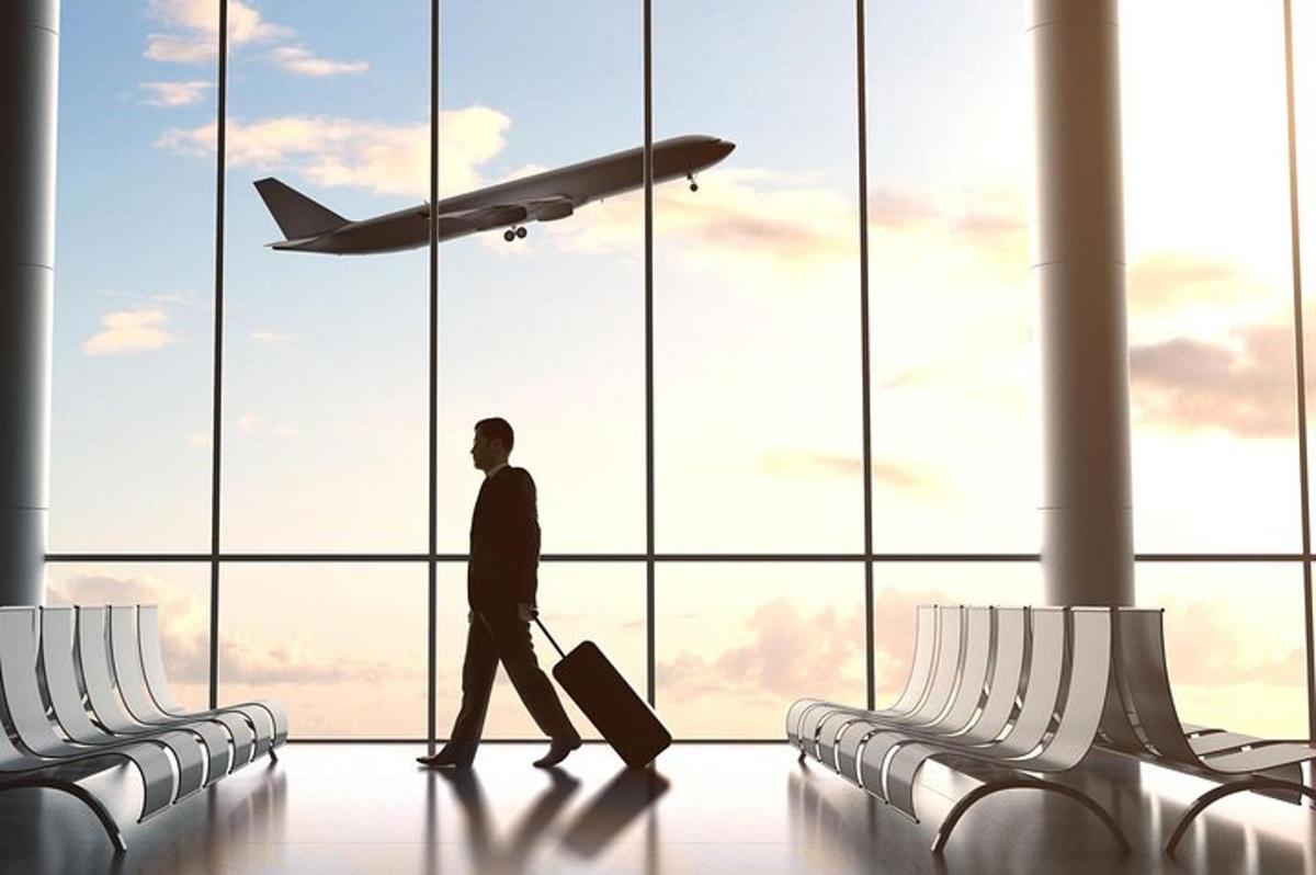 a man walking through an airport with an airplane
