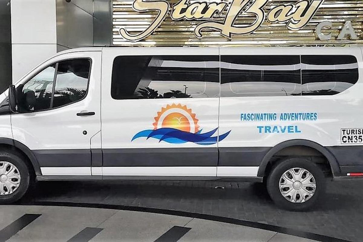 sebuah van putih dengan papan tanda untuk teksi