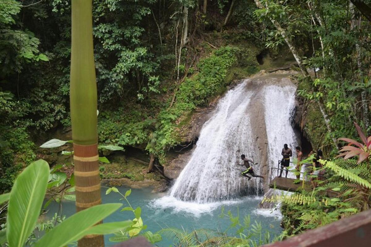 a group of people standing in front of a waterfall