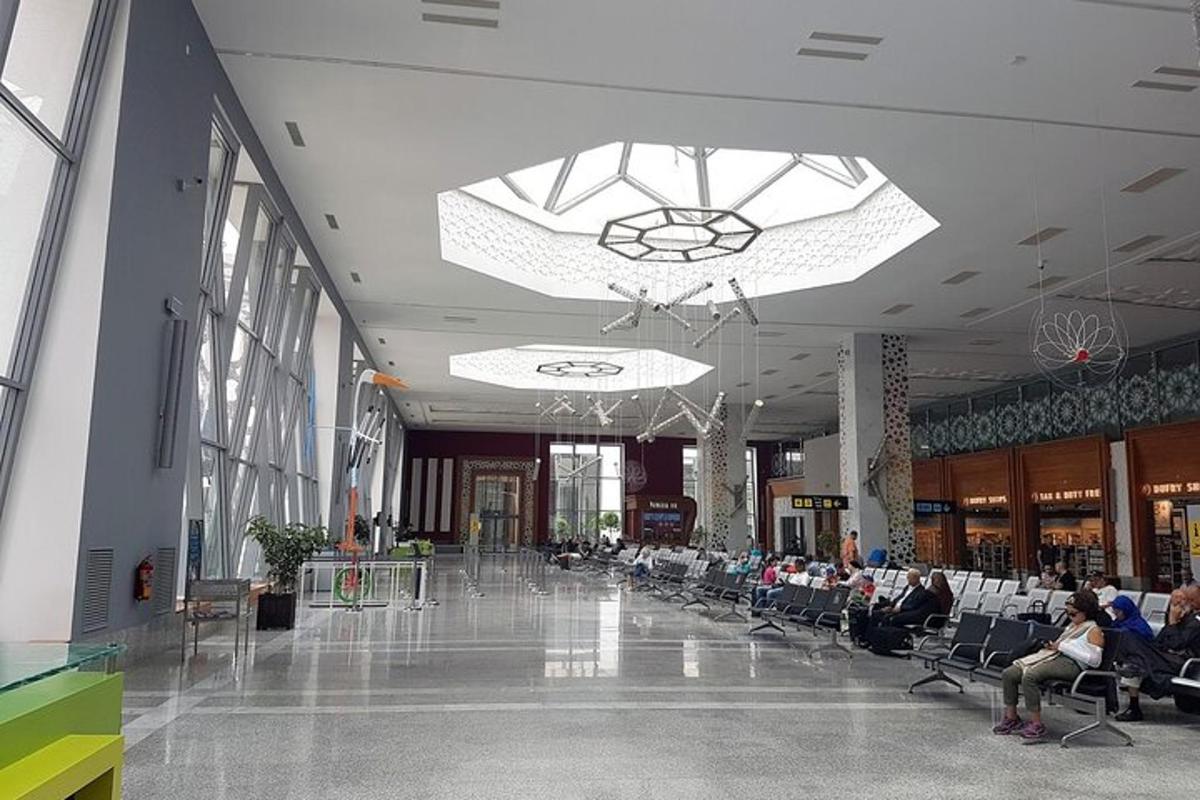 a lobby with people sitting in chairs in a building