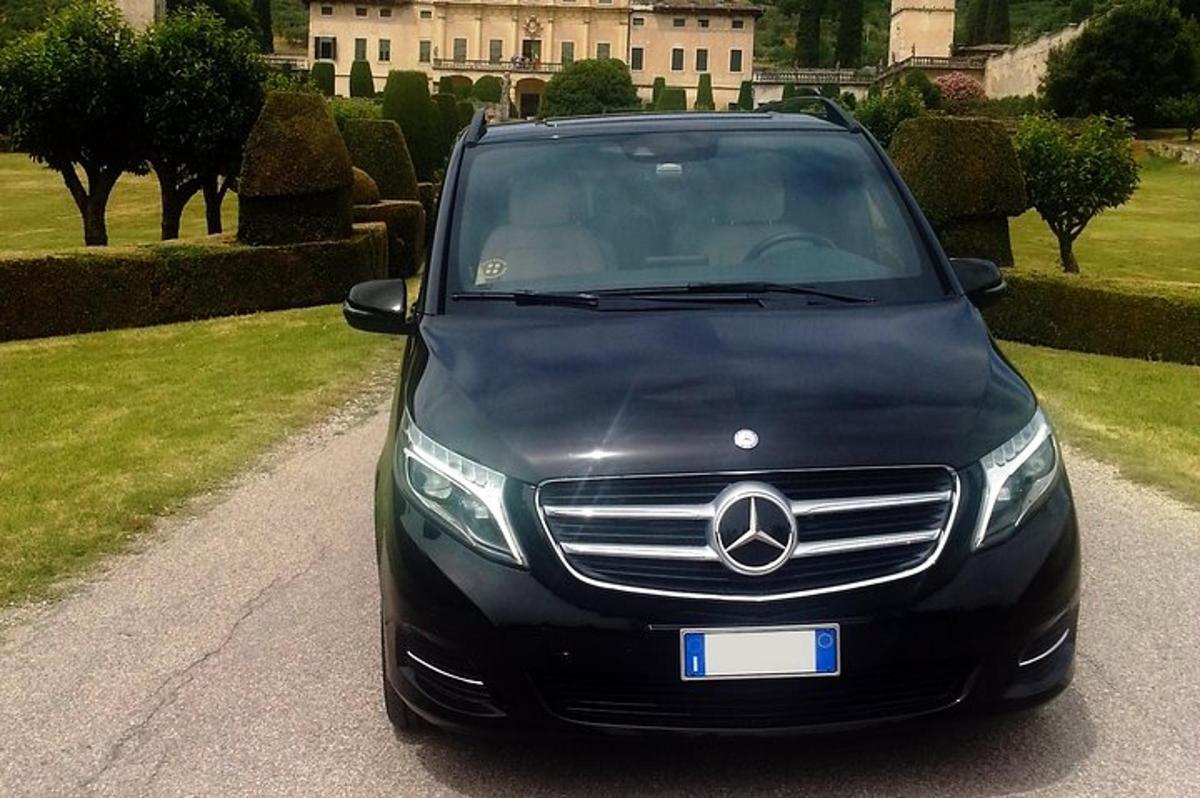 a black car parked in front of a house