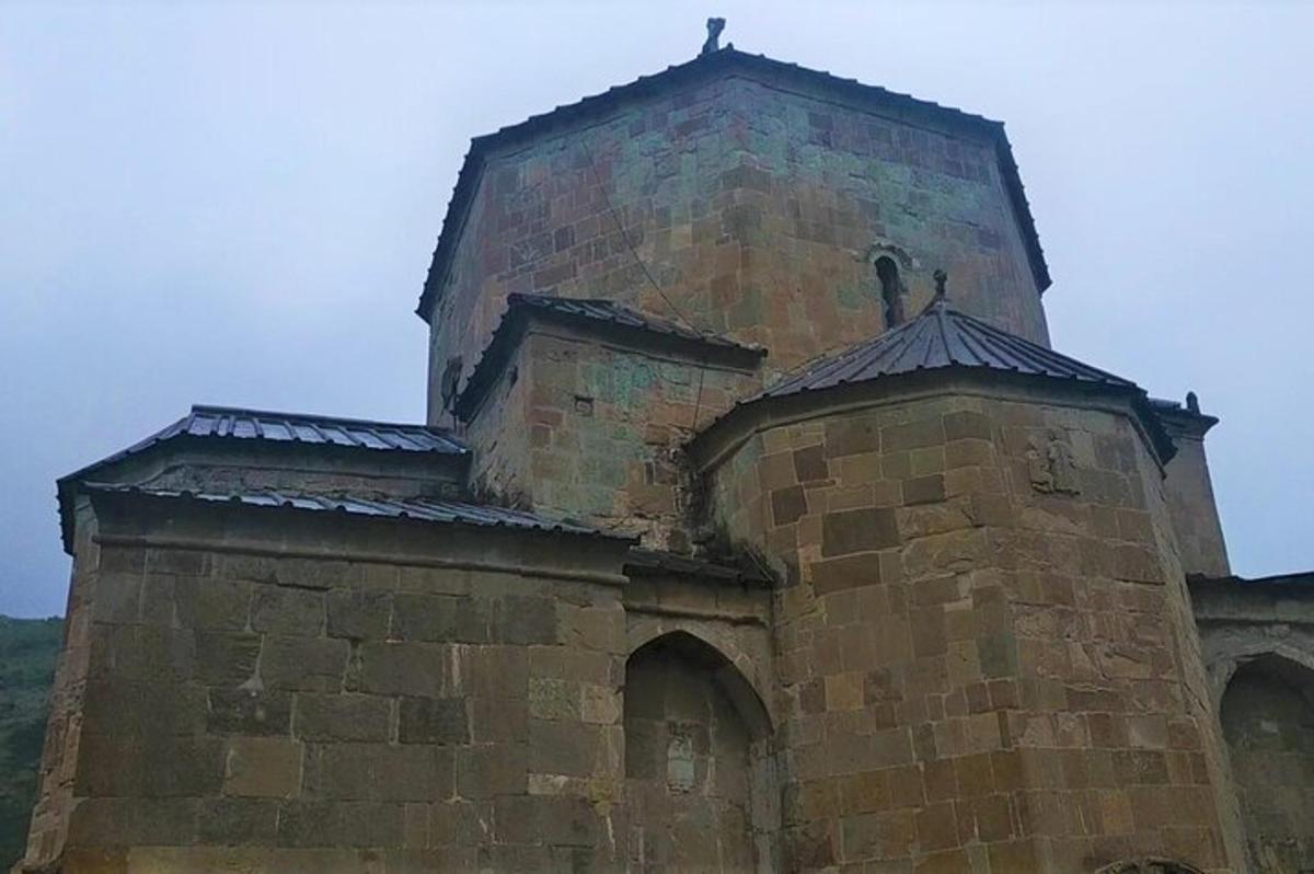 Un viejo edificio de ladrillo con una cruz encima.