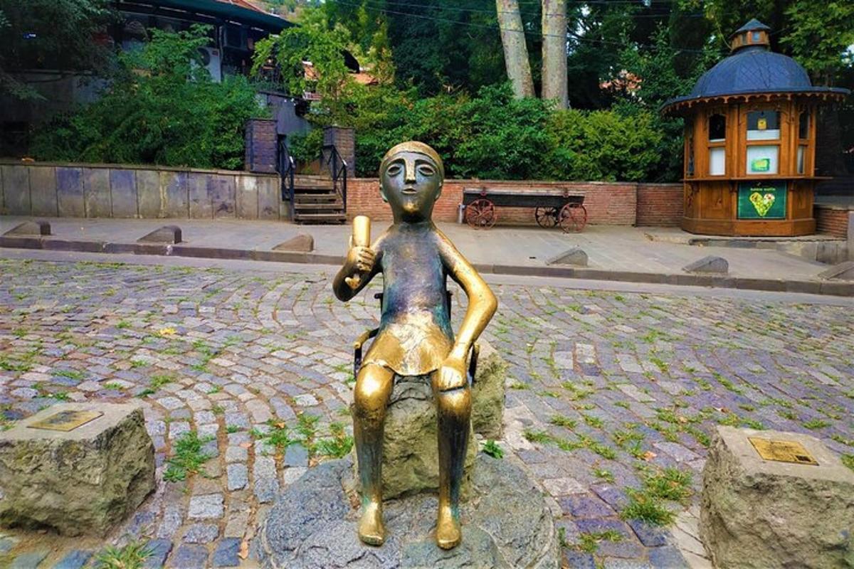 a statue of a person sitting on a rock