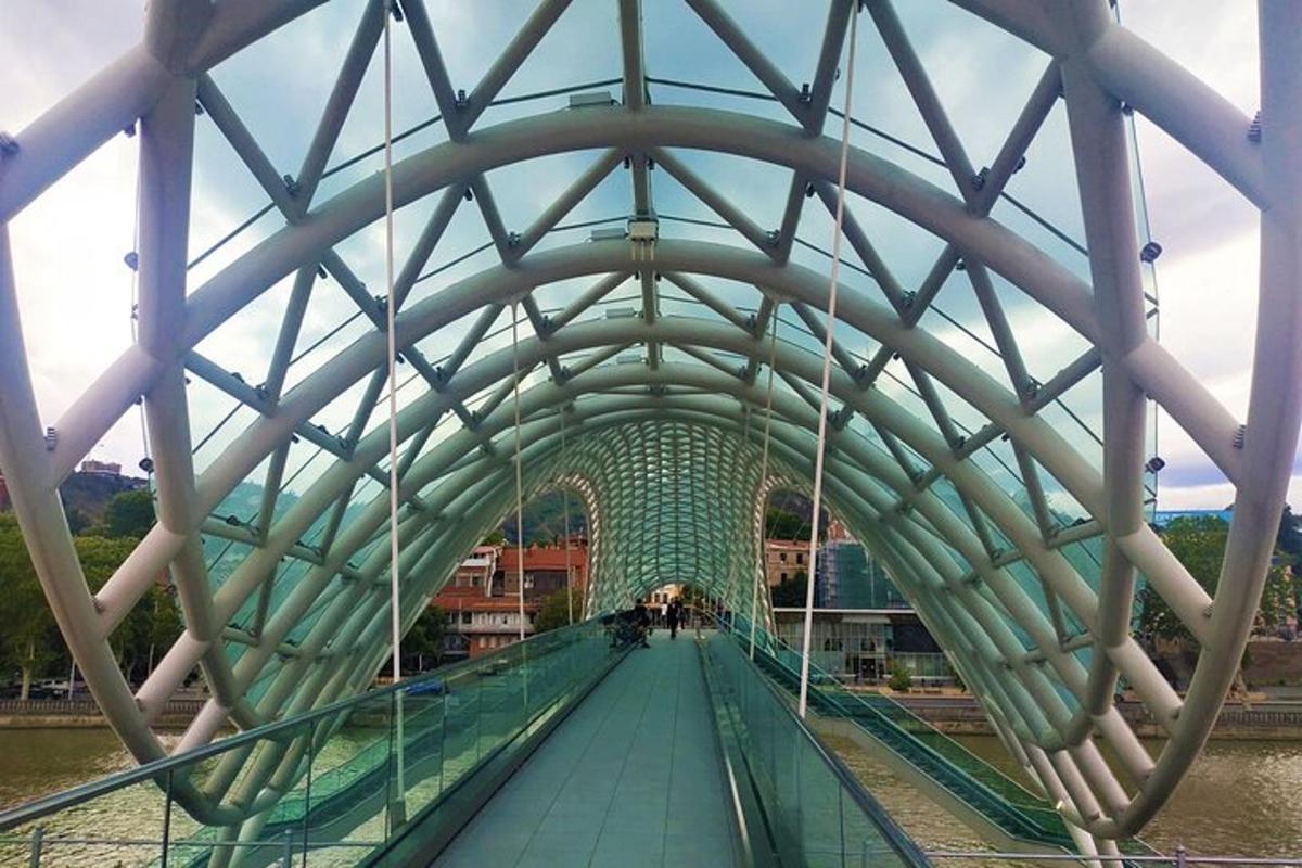 a bridge over a river with a glass ceiling