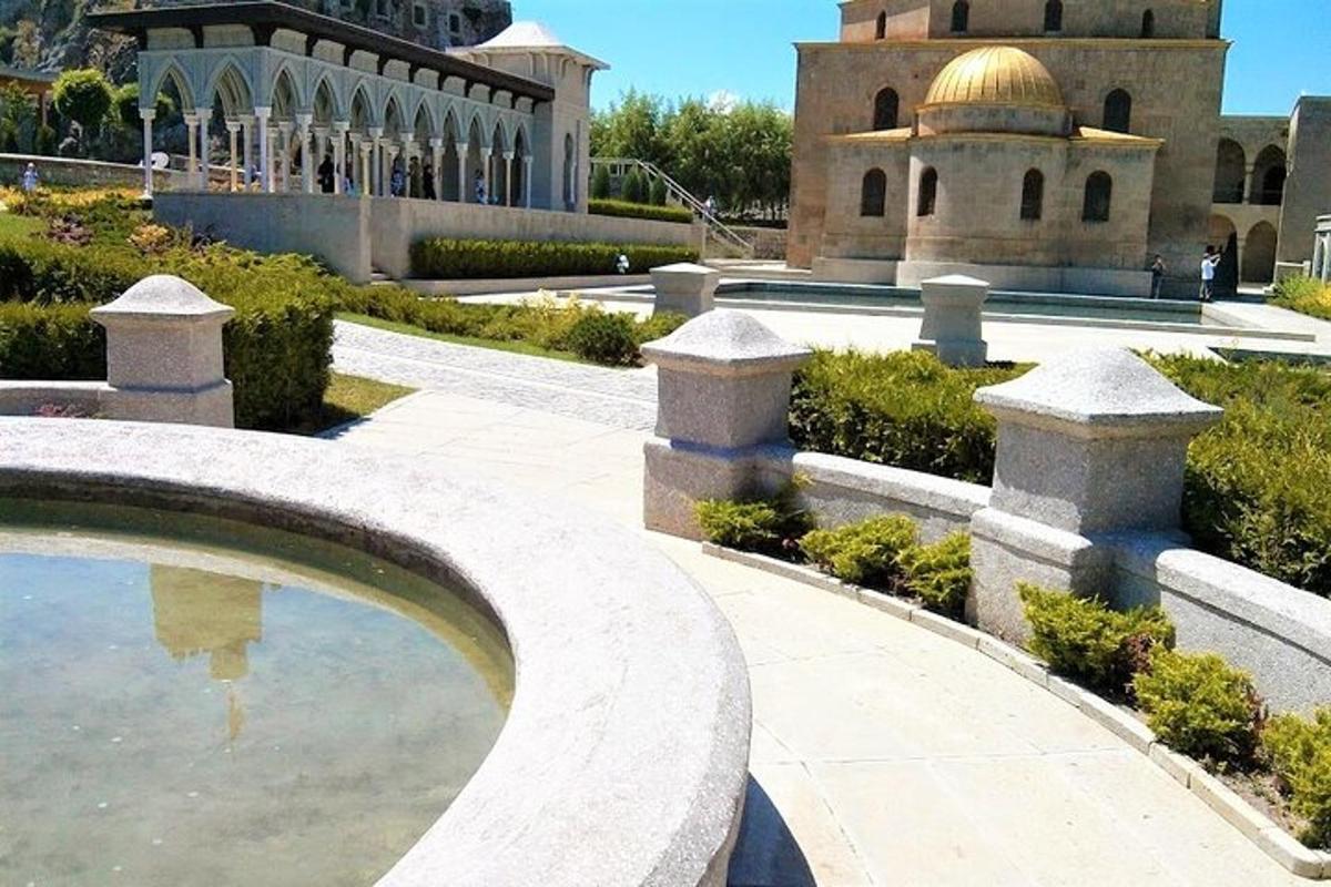 a building with a dome and a pool of water