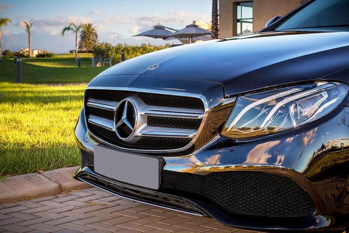 a front end of a car parked on a sidewalk