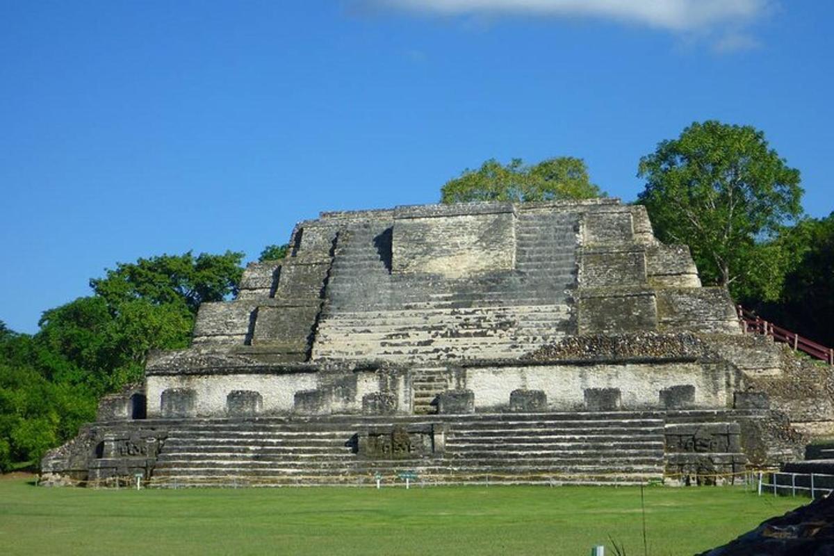 an ancient pyramid with a field in front of it