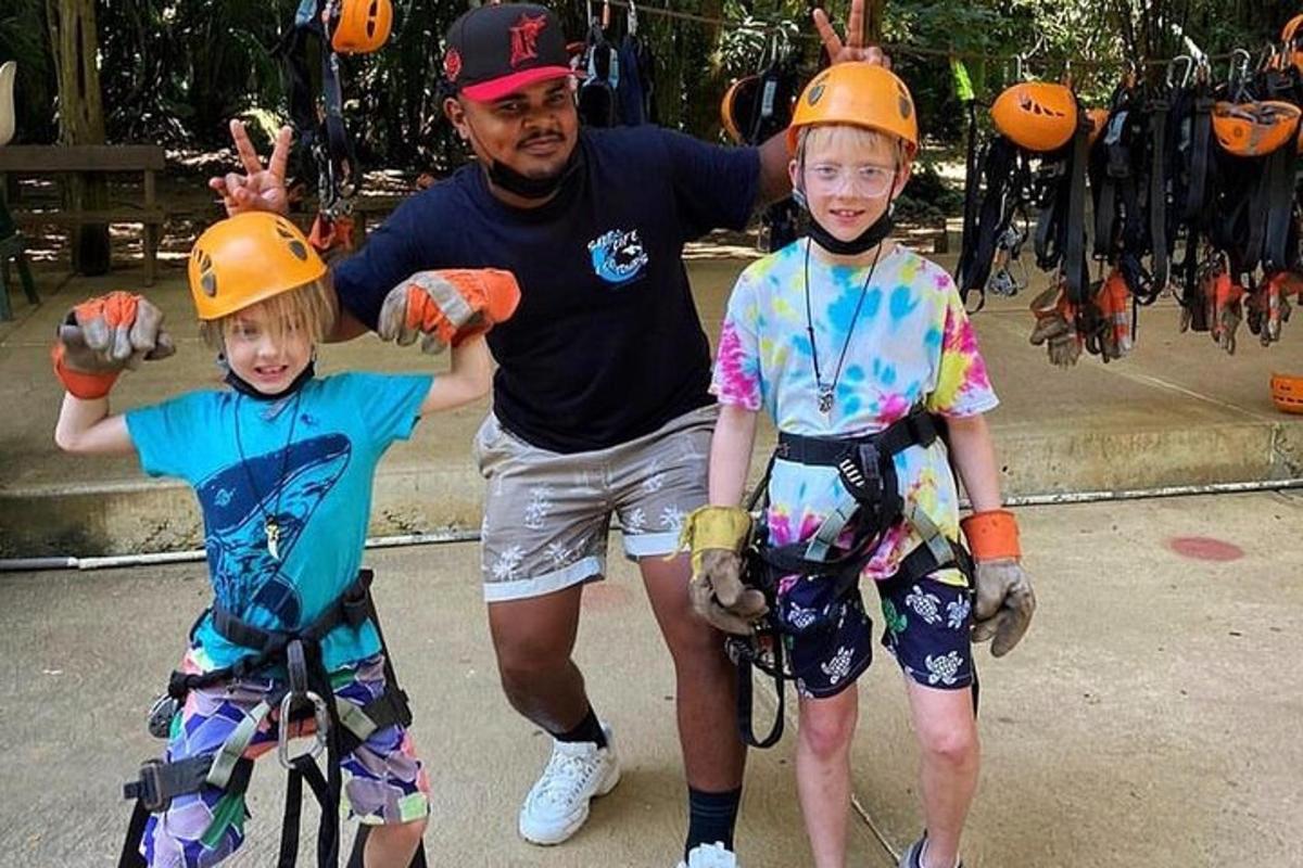 a man and two children wearing helmets and gloves