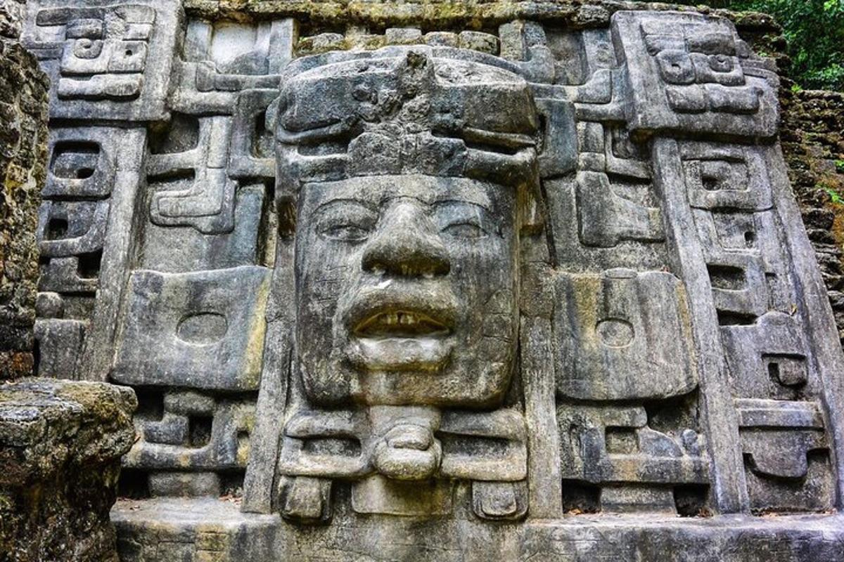 a stone sculpture of a face on a wall