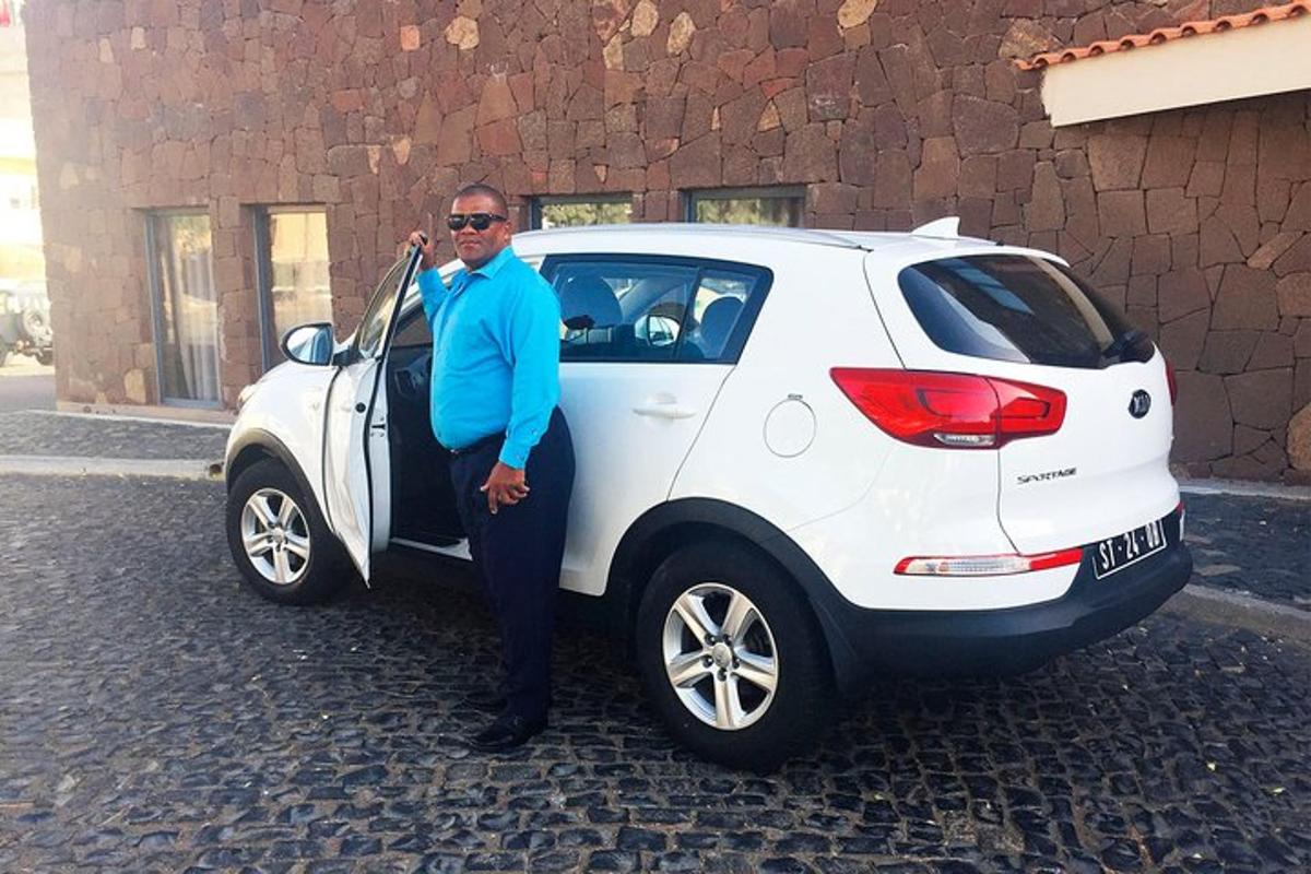a man is standing next to a white car
