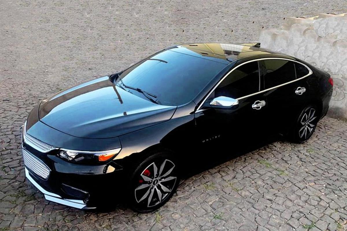 a small black car parked on the street