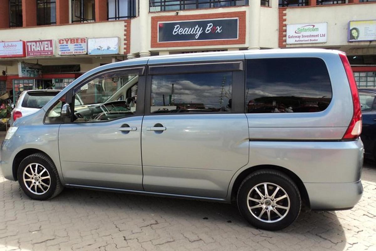 a silver van parked in front of a building
