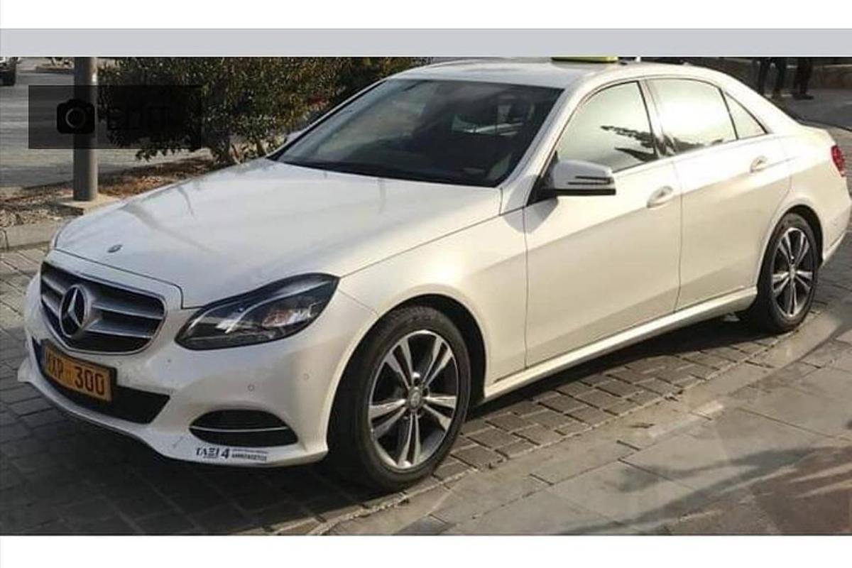 a white car parked on the side of a street