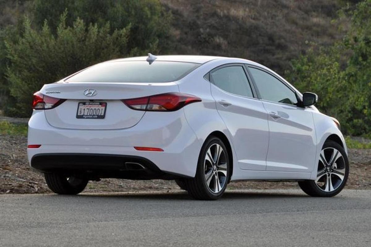 a whiteonda civic hatchback parked on a road