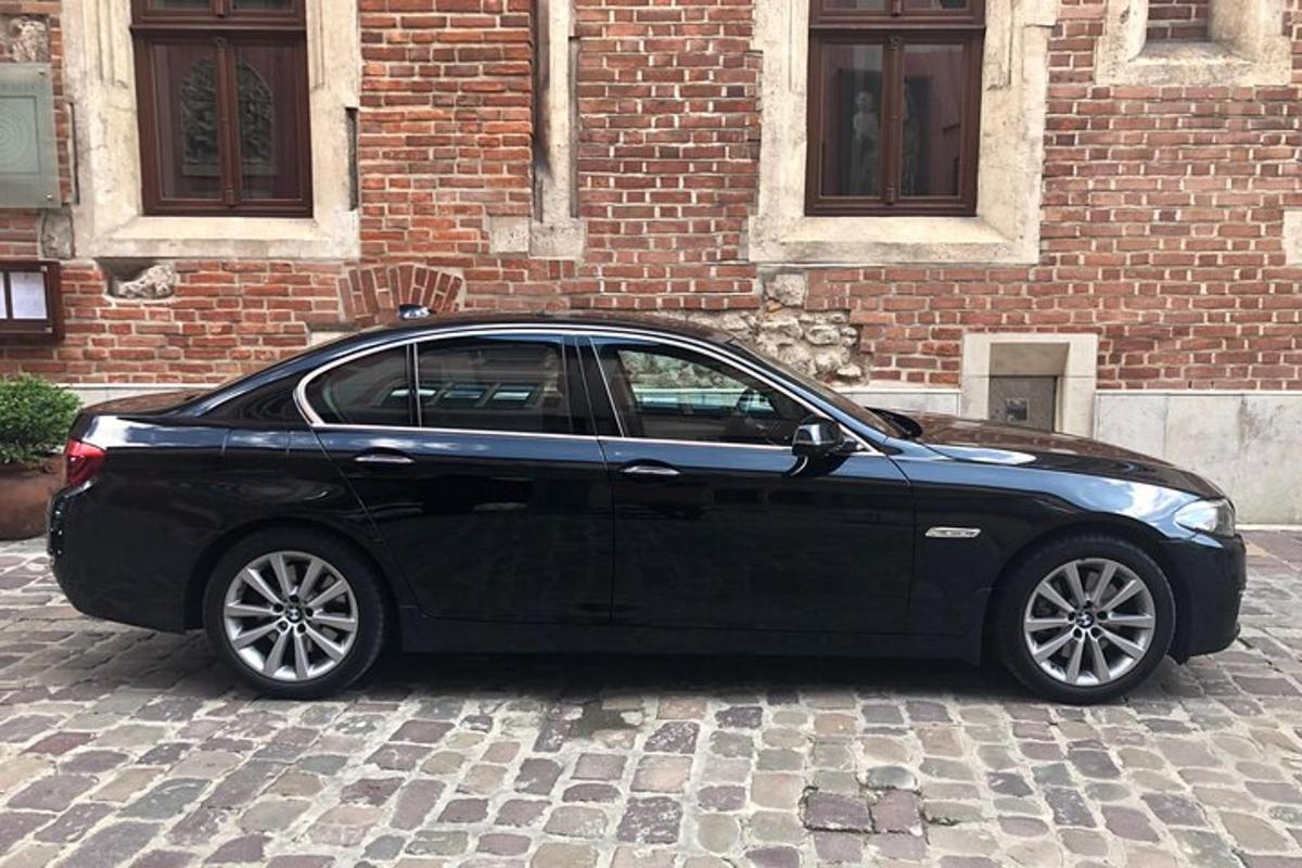 un'auto nera parcheggiata davanti a un edificio in mattoni