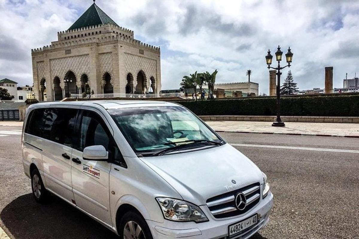 a white van parked in front of a building
