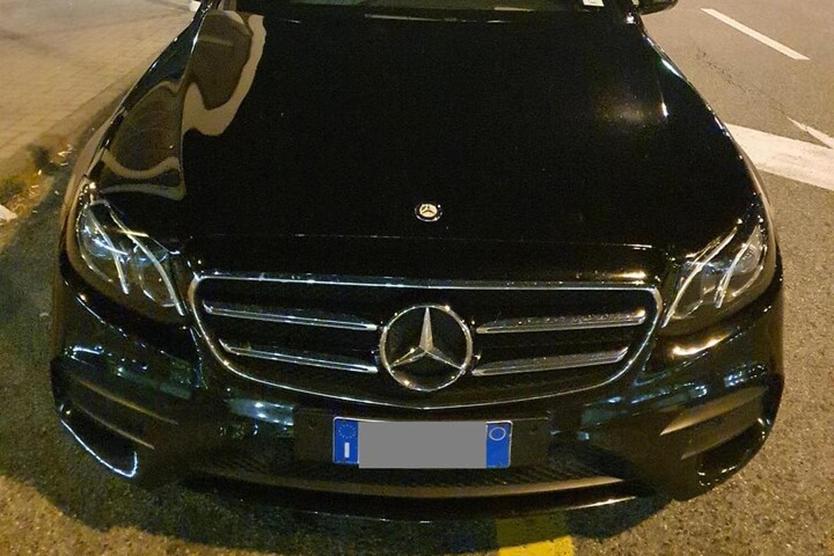 Mercedes Benz bíll lagður á bílastæði