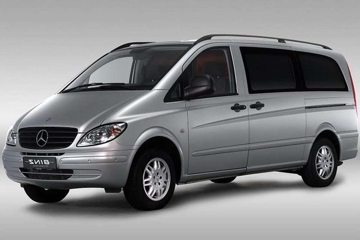 a silver van is parked on a white background