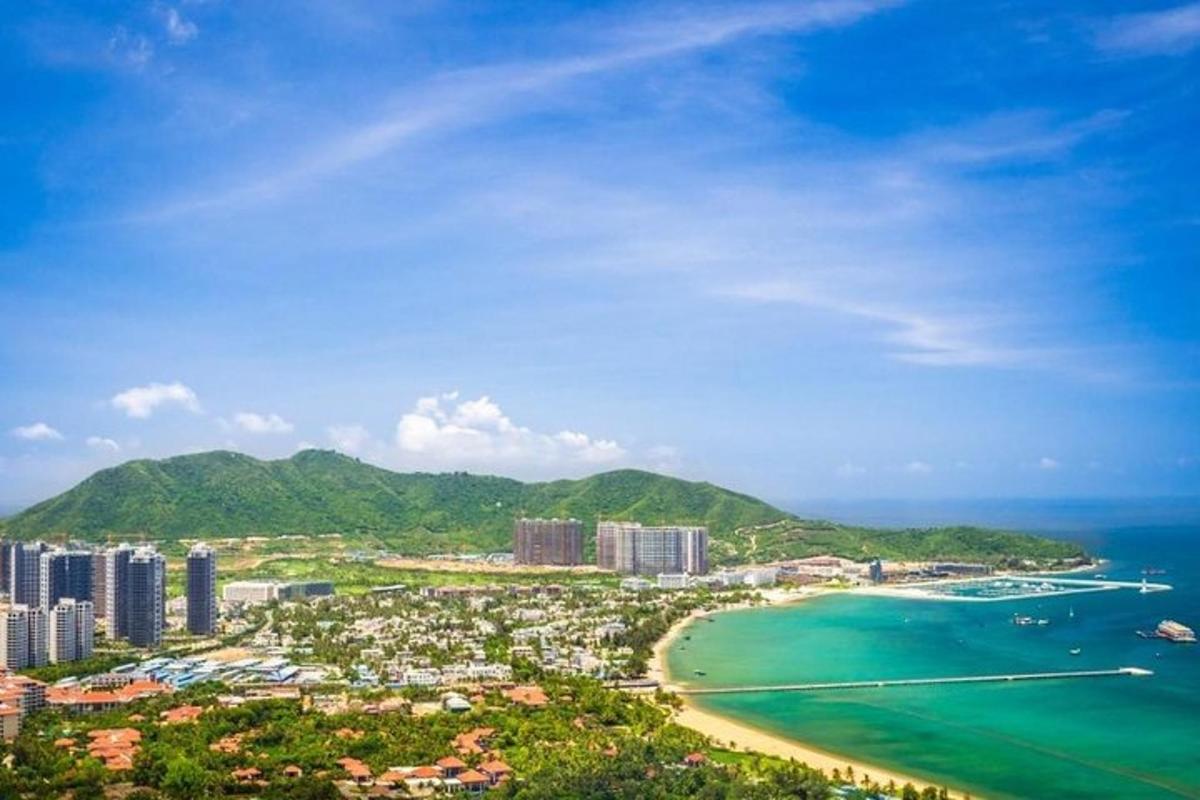 a view of a beach with buildings and the ocean