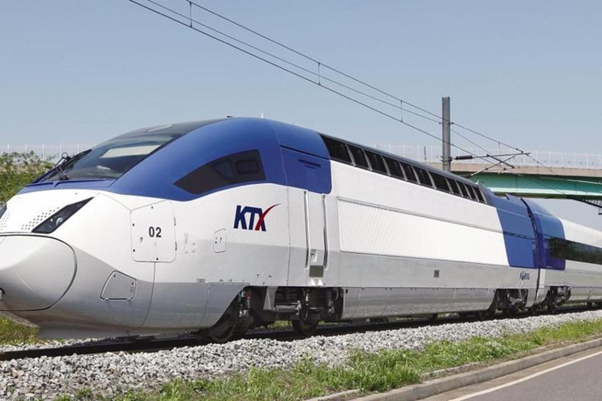 a blue and white train on the tracks
