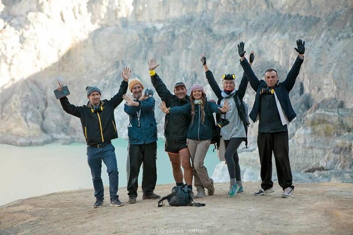 a group of people standing on top of a mountain