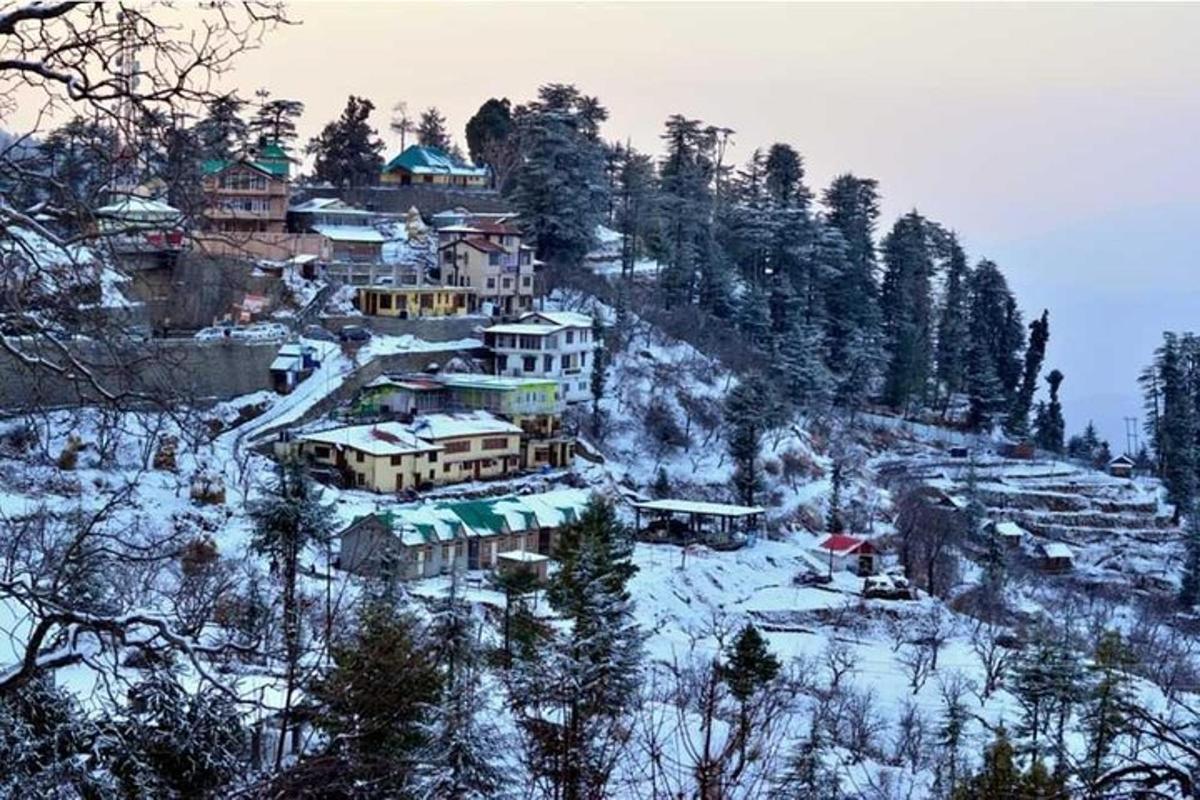 a group of houses on a snow covered mountain
