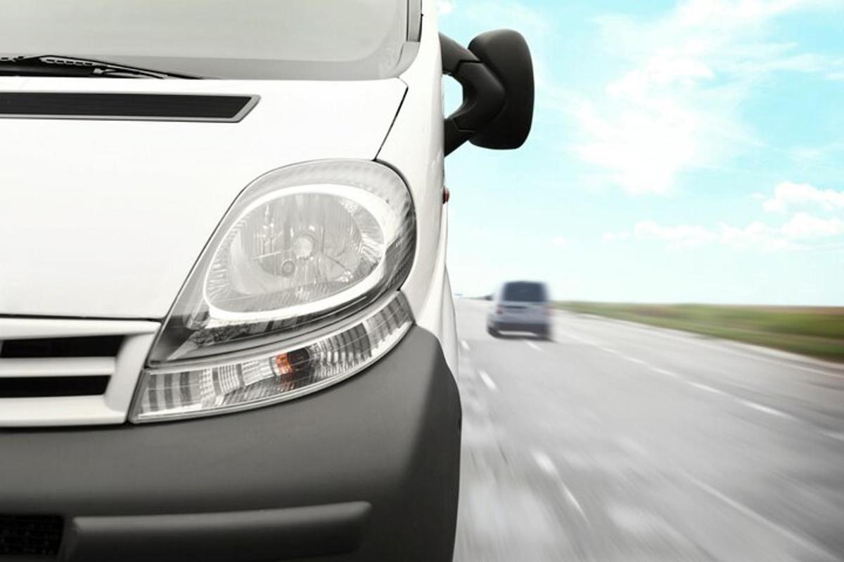 a white van driving down a highway