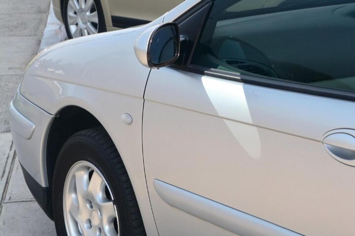 a white car parked on the side of a street