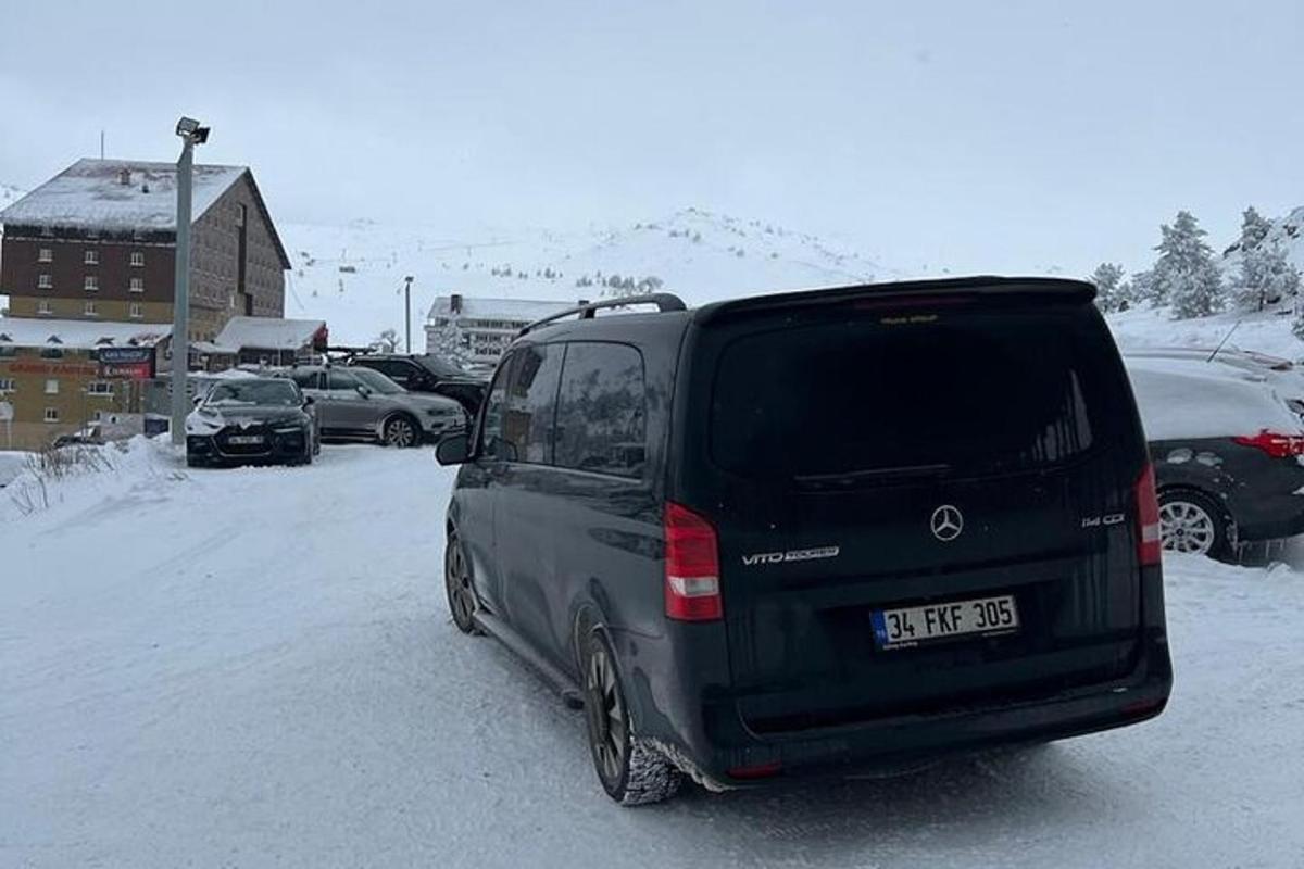 a black van parked in a snow covered parking lot