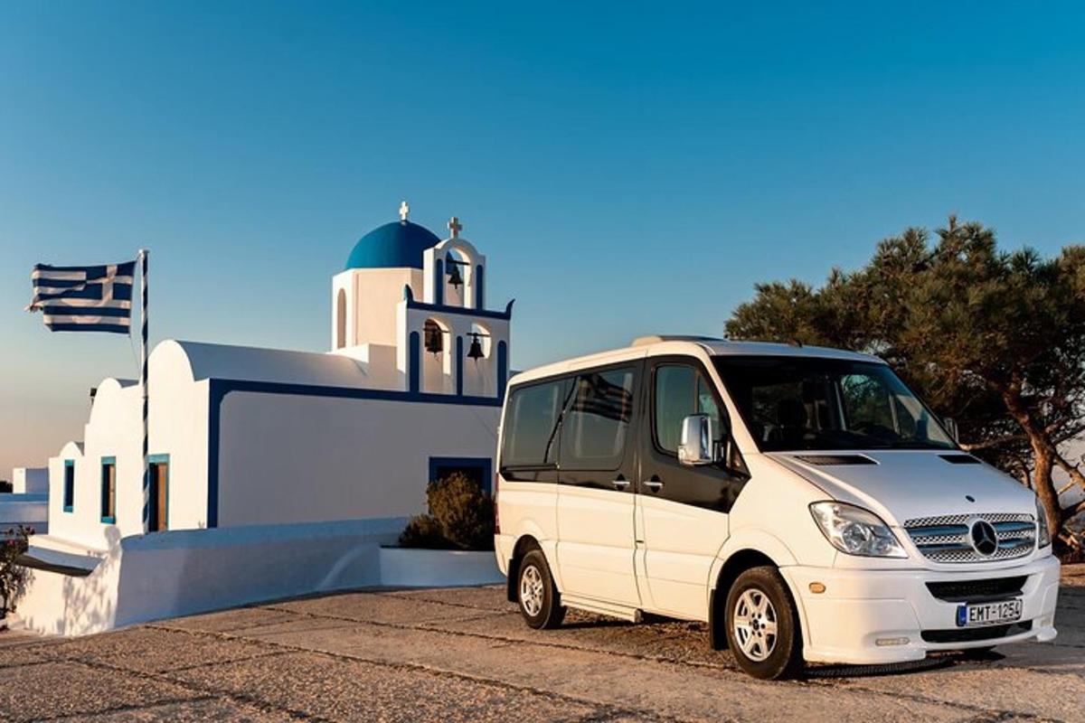 mažas baltas mikroautobusas, pastatytas priešais pastatą