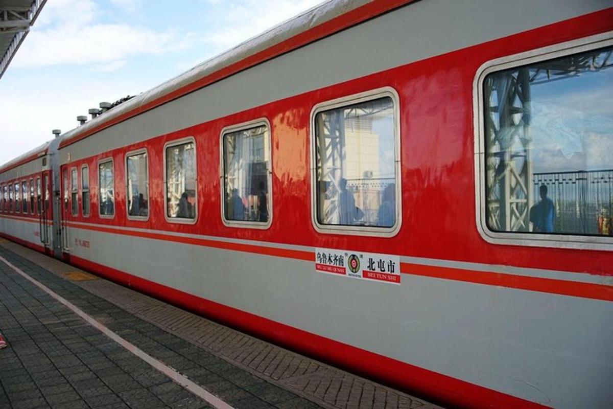 a red and white train at a train station