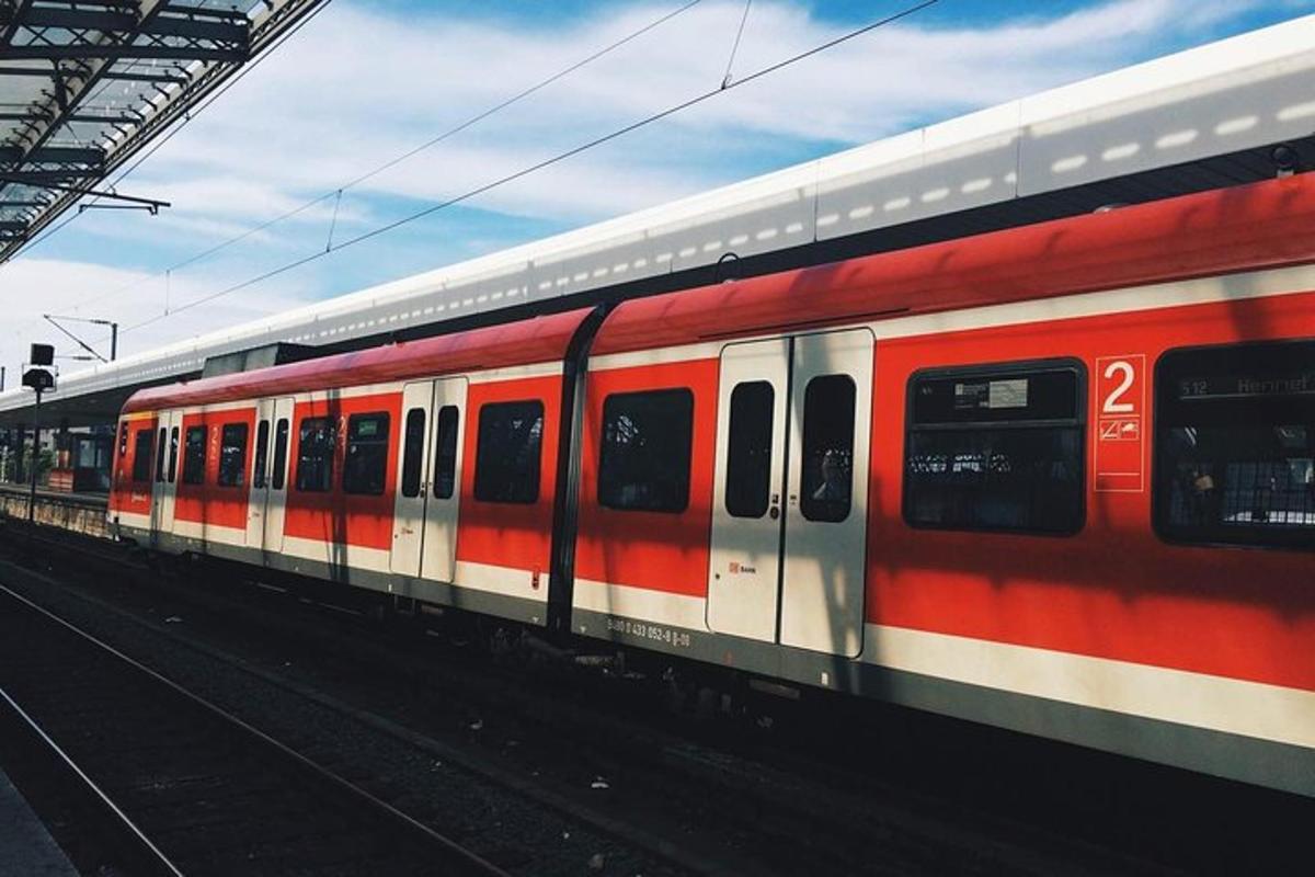 a red and white train on the tracks