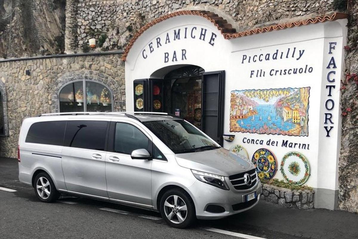 una furgoneta platejada aparcada davant d'un bar