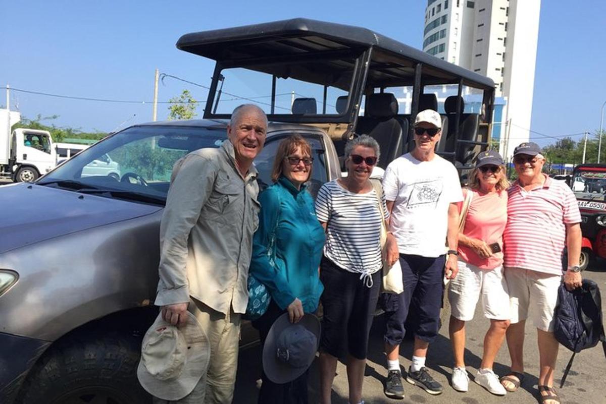 a group of people standing in front of a car