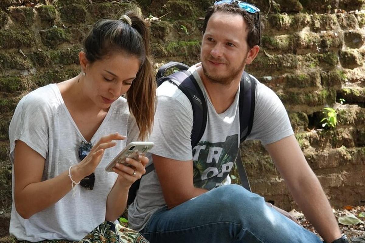 a man and a woman looking at a cell phone