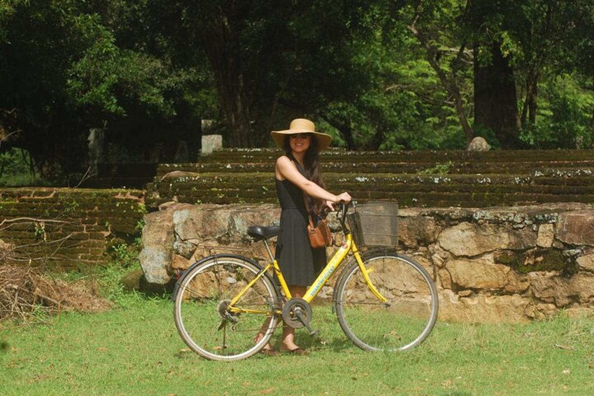 a woman in a hat standing next to a bike
