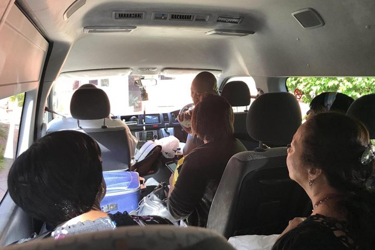 isang grupo ng mga tao na nakaupo sa likod ng isang van