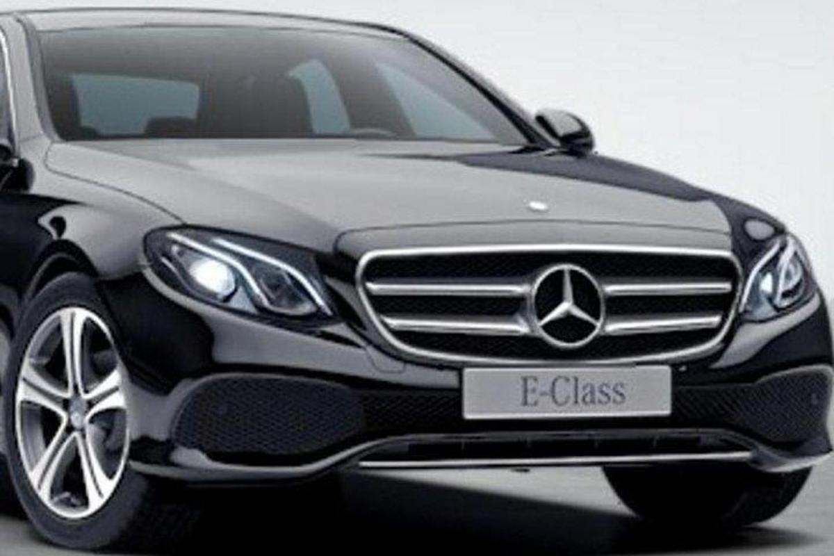 a black mercedes benz car with a license plate