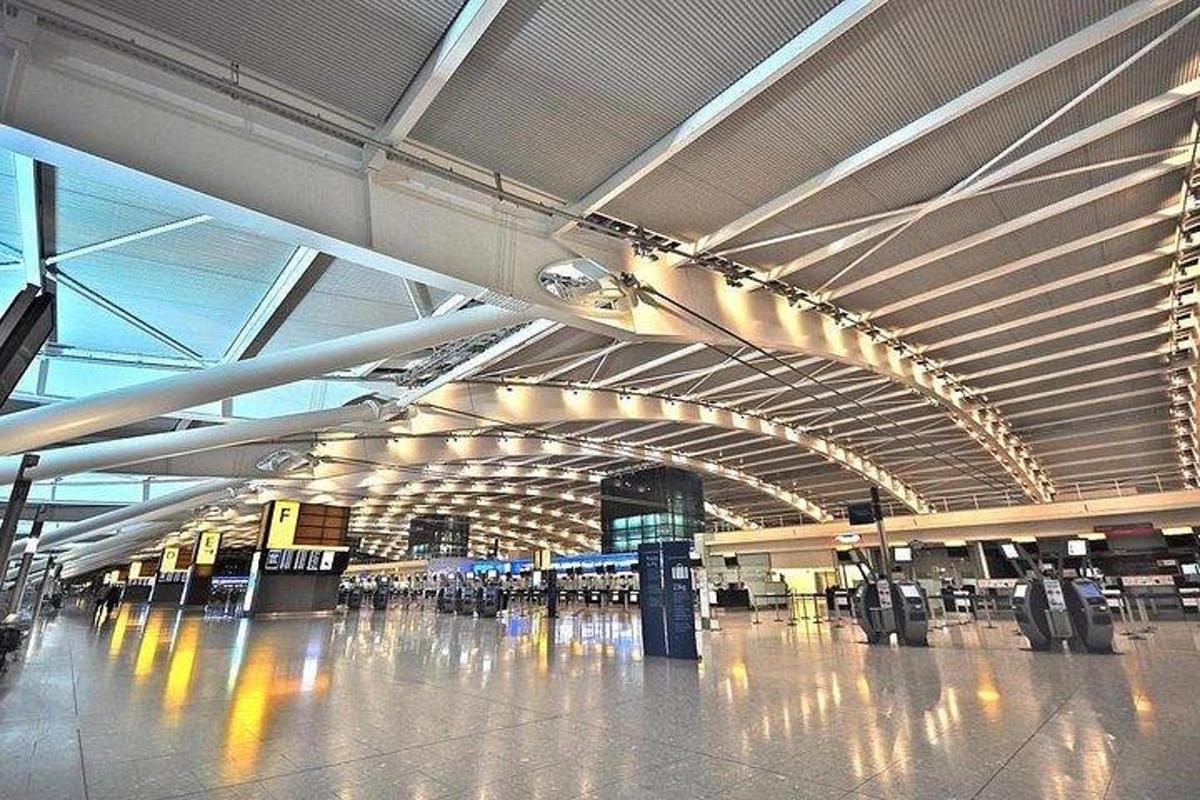 an empty airport terminal with a lot of luggage carts